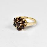A 9ct gold garnet cluster ring, the head with seven claw set round garnets,