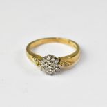 A 9ct gold ring with diamond flowerhead cluster, with two diamonds to each shoulder, size P,