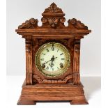 ANSONIA CLOCK CO, NEW YORK; an oak cased mantel clock with architectural pediment,