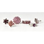 Six sterling silver garnet and topaz rings,