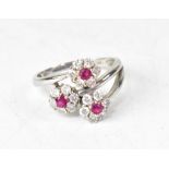 A modern contemporary 14ct white gold diamond and ruby ring,