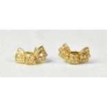 A pair of 18ct yellow gold stud earrings in the form of bows set with diamonds,