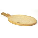 ROBERT MOUSEMAN THOMPSON OF KILBURN; a hand carved oak cheese board of oval form,