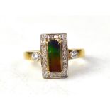 A 9ct gold claw set rectangular multicoloured ammolite, in a rectangular mount of tiny diamonds,