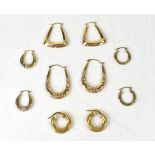 Five pairs of gold earrings of hoop design, four pairs marked '9K', the largest pair unmarked,