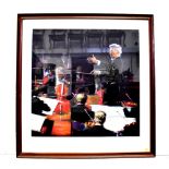 HERBERT VON KARAJAN; a large framed limited edition print, Von Karajan conducting an orchestra,