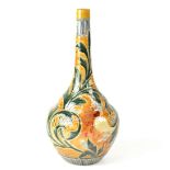 DOULTON LAMBETH; a long-necked onion vase with scrolling foliate design on a burnt orange ground,