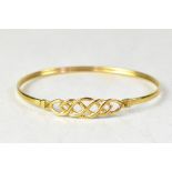 A modern 9ct gold bracelet of plain design, the top with a Celtic ropetwist shape,