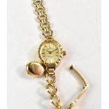 SOVEREIGN; a 9ct gold ladies' wristwatch, the oval silvered dial set with raised baton numerals,