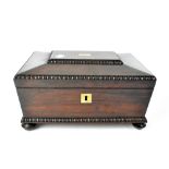 A Georgian rosewood sarcophagus-shaped work box with egg and dart moulding and blank brass