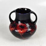 WILLIAM MOORCROFT; an early 20th century twin-handled vase decorated with the 'Big Poppies' pattern,