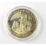 An American five dollar commemorative 'First Man on the Moon' encapsulated coin.