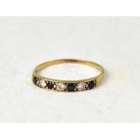 A 9ct gold sapphire and white stone half eternity ring,