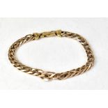 A 9ct gold flat curb bracelet with lobster claw clasp, length 22cm, approx 19.5g.