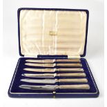 A cased set of six Harrods of London silver handled cake knives, with Art Deco style finials,