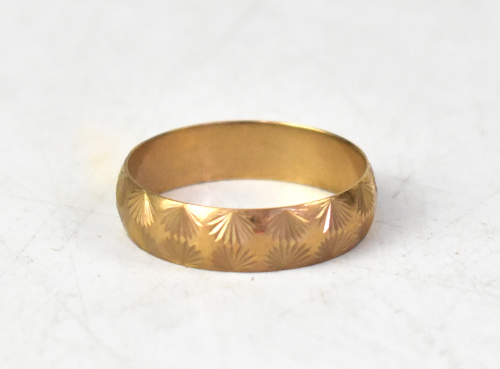 A large 9ct gold band ring, with a double row of mirrored floral pattern, size Z, approx 3.8g.