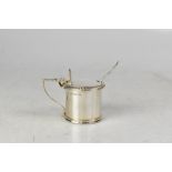 An Elizabeth II hallmarked silver lidded mustard pot with shell thumb kick on acanthus embellished