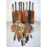 A large collection of vintage sports equipment, including golf clubs,