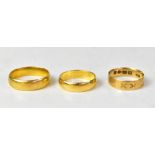 Three yellow gold wedding bands, comprising two 22ct examples, sizes O1/2 and S, combined approx 11.