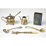 A hallmarked silver mustard pot with C-scroll handle and blue liner, on three pad feet,