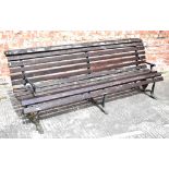 A late 19th early 20th century long cast iron and wood slatted bench,