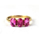 A 9ct gold three-stone Cruzeiro rubellite ring, on a 9ct yellow gold shank, size S, approx 2.4g.