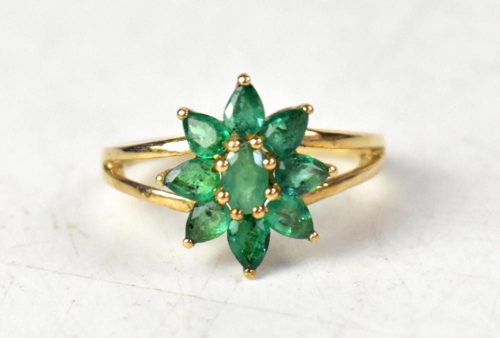 A 9ct yellow gold ring set with Terezinha emerald flowerhead with split shoulders,