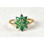 A 9ct yellow gold ring set with Terezinha emerald flowerhead with split shoulders,