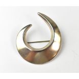 GEORG JENSEN; a Danish silver brooch in the form of a crescent, Georg Jensen and 925 mark to back,