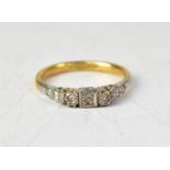 An 18ct gold Art Deco style ring with a central small claw set diamond in a square mount,