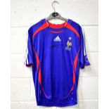 FRANCE; a c2006 Adidas football shirt bearing the signature of Zinedine Zidane,