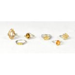 Six sterling silver citrine and Cognac quartz rings,