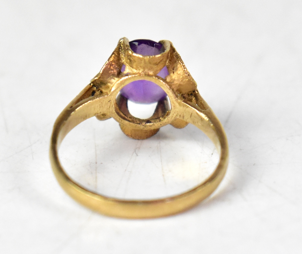 A yellow metal ring set with an oval amethyst in an open work floral mount, marks indistinct, - Bild 3 aus 3