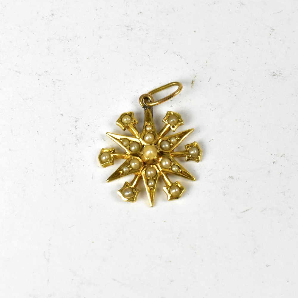 A vintage 15ct gold seed pearl encrusted star pendant, length 2cm, approx 2.1g.