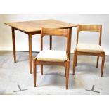 A 1970s vintage extending dining table on four turned tapered supports,