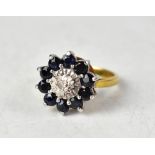 A 9ct yellow gold cluster ring set with a central diamond surrounded by sapphires, size M1/2,