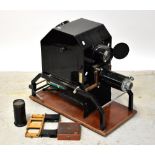 An Epidiascope mounted on wooden base, the lens inscribed 16" Anastigmat Epidiascope Lens F.3.