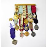 MASONIC INTEREST; a cased set comprising fourteen miniature Masonic medals,