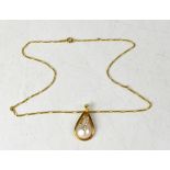 An 18ct gold pendant set with a teadrop-shaped pearl, and tiny diamonds,