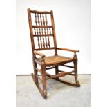A 19th century rush seated bobbin back Lancashire-style provincial rocking chair.