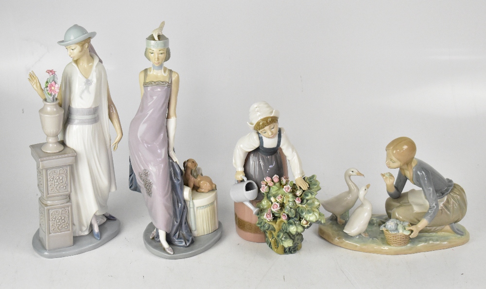 LLADRÓ; four large porcelain figure groups, comprising an Art Deco lady with puppy by seat,