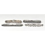 Four sterling silver backed bracelets, comprising a black diamond cluster bow link bracelet,