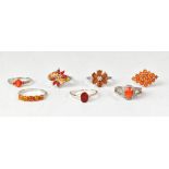 Seven orange fire opal and topaz sterling silver rings,