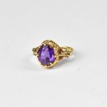 A 9ct gold amethyst ring, oval claw set amethyst in fancy mount, size O, approx 2.7g.