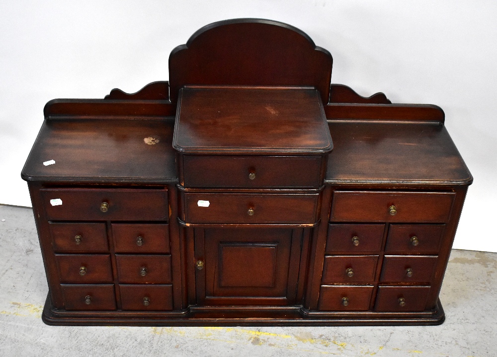 An early/mid-20th century cottage made stained wooden cabinet with galleried top,