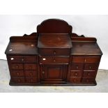 An early/mid-20th century cottage made stained wooden cabinet with galleried top,