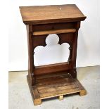 A Victorian carved oak lecturn with sloped top above a carved base with two star motifs with fleur