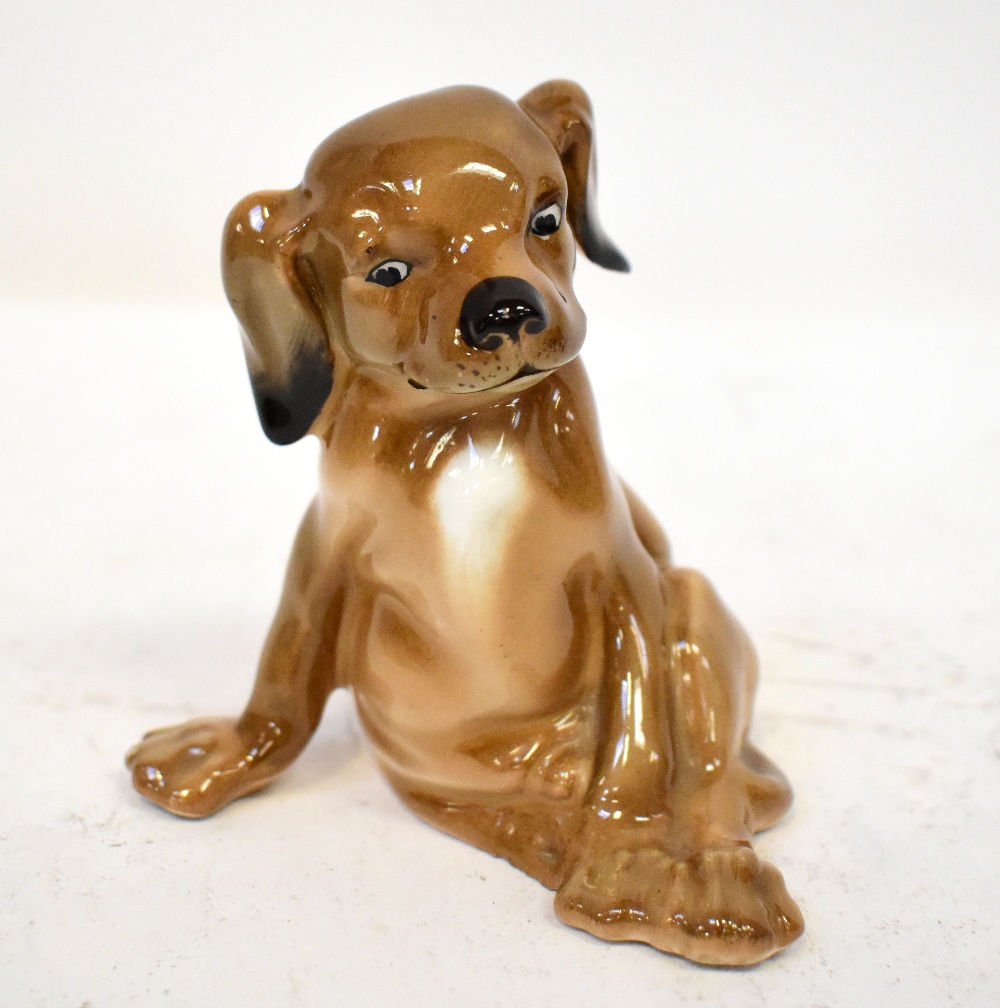 ROYAL DOULTON; an early 20th century porcelain figure of a seated puppy, HN128,