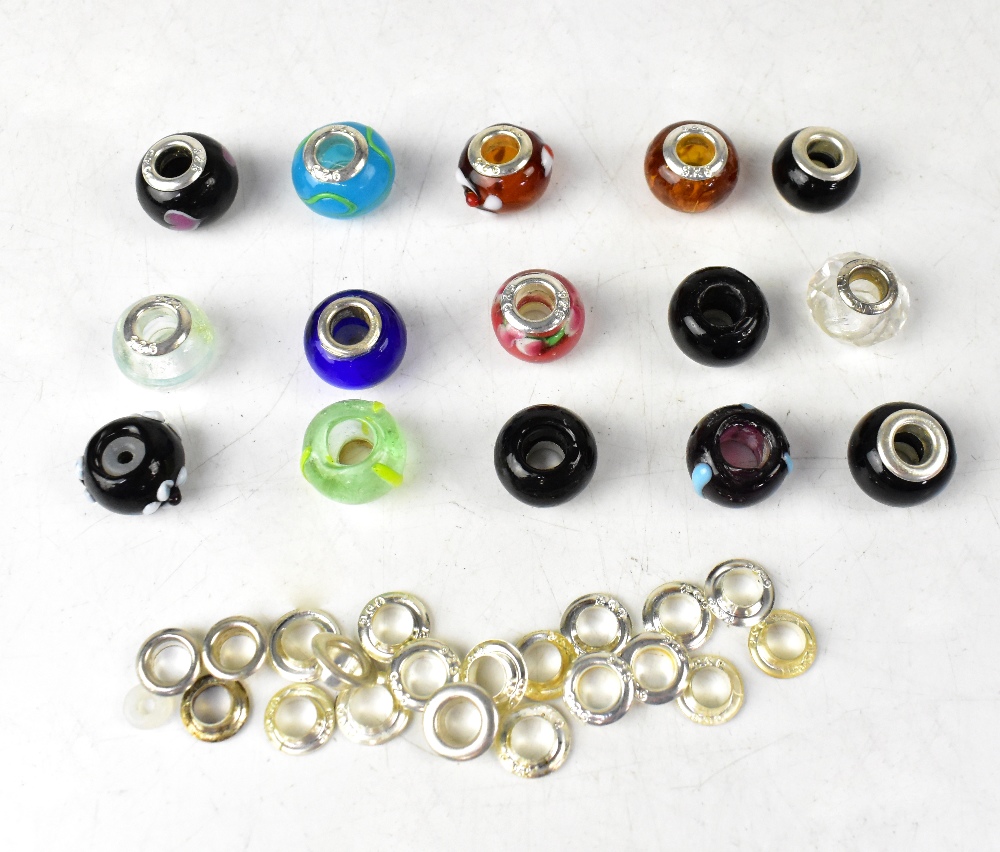 A quantity of sterling silver mounted glass beads and spare sterling silver mounts,