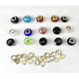 A quantity of sterling silver mounted glass beads and spare sterling silver mounts,